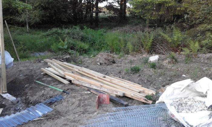 pile of rubble in garden with planks of wood